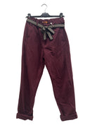 Maroon pants with a decorative belt on a white background