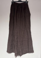 Brown skirt on a hanger against a white background