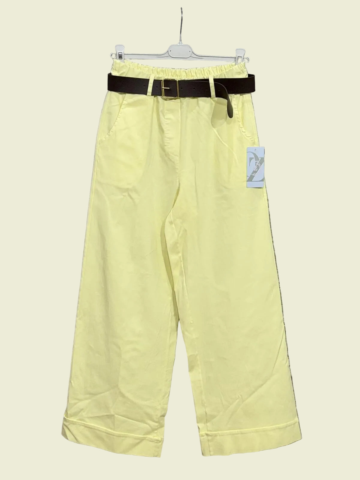 Light yellow pants with a black belt 