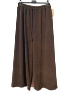 A pair of brown wide-leg cropped pants with an elastic waistband and tie