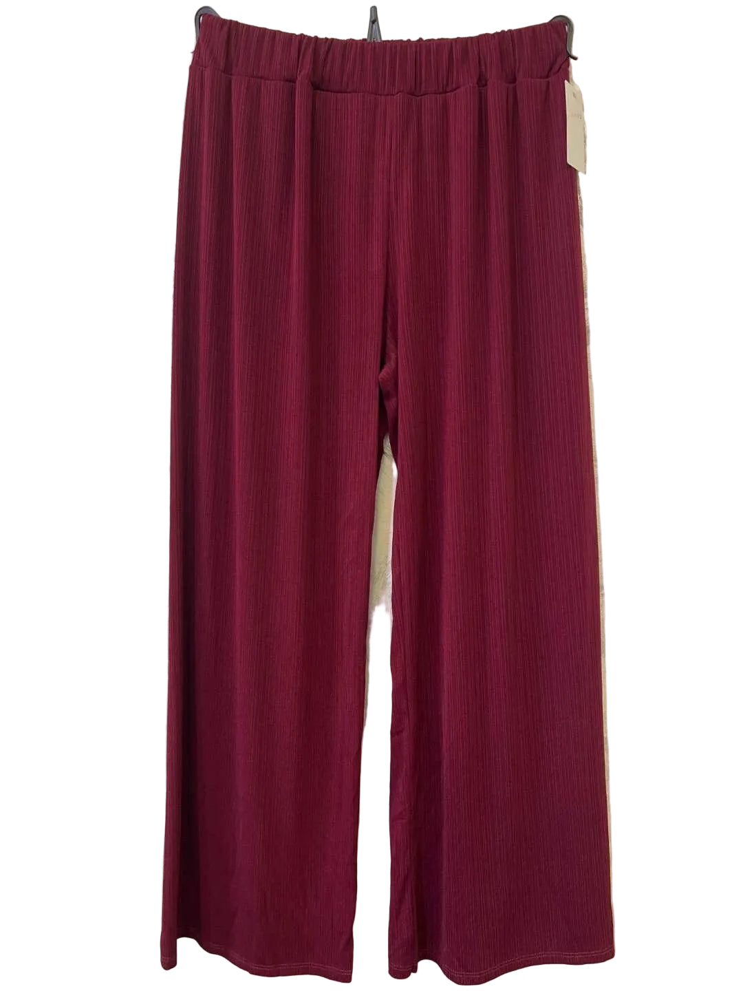 A pair of wide-leg trousers in a deep burgundy colour