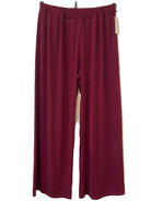 A pair of wide-leg trousers in a deep burgundy colour