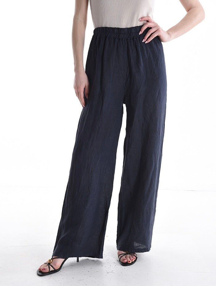 Navy wide-leg pants worn by a person on a white background