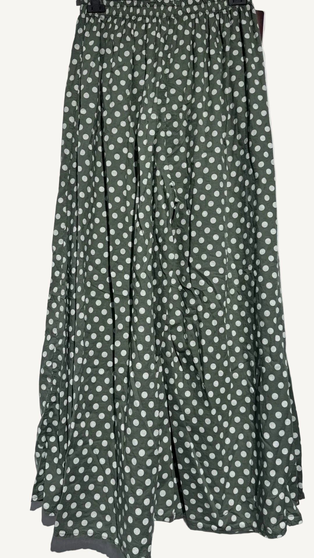 Green pants with white polka dots on a white background