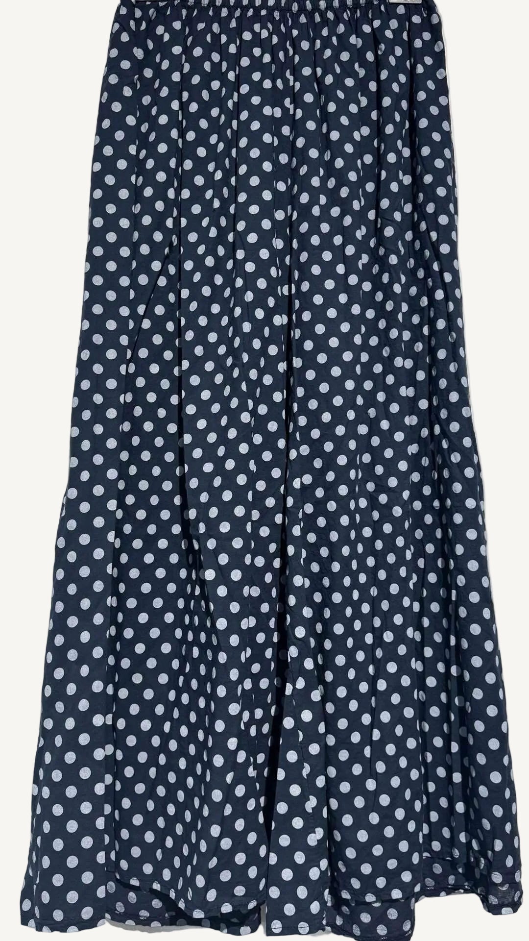 Navy blue pants with white polka dot pattern on a white background