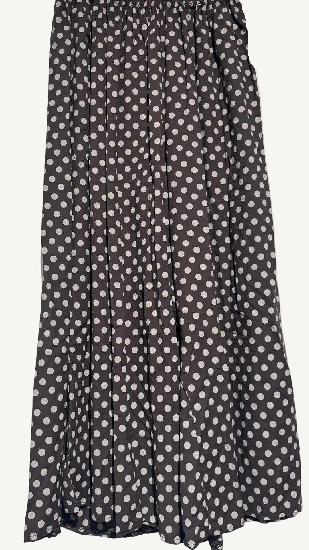 Brown trousers with white polka dot pattern on a plain background