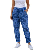 Person wearing blue floral pants with a white background.
