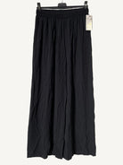 Black wide-leg pants on a hanger 