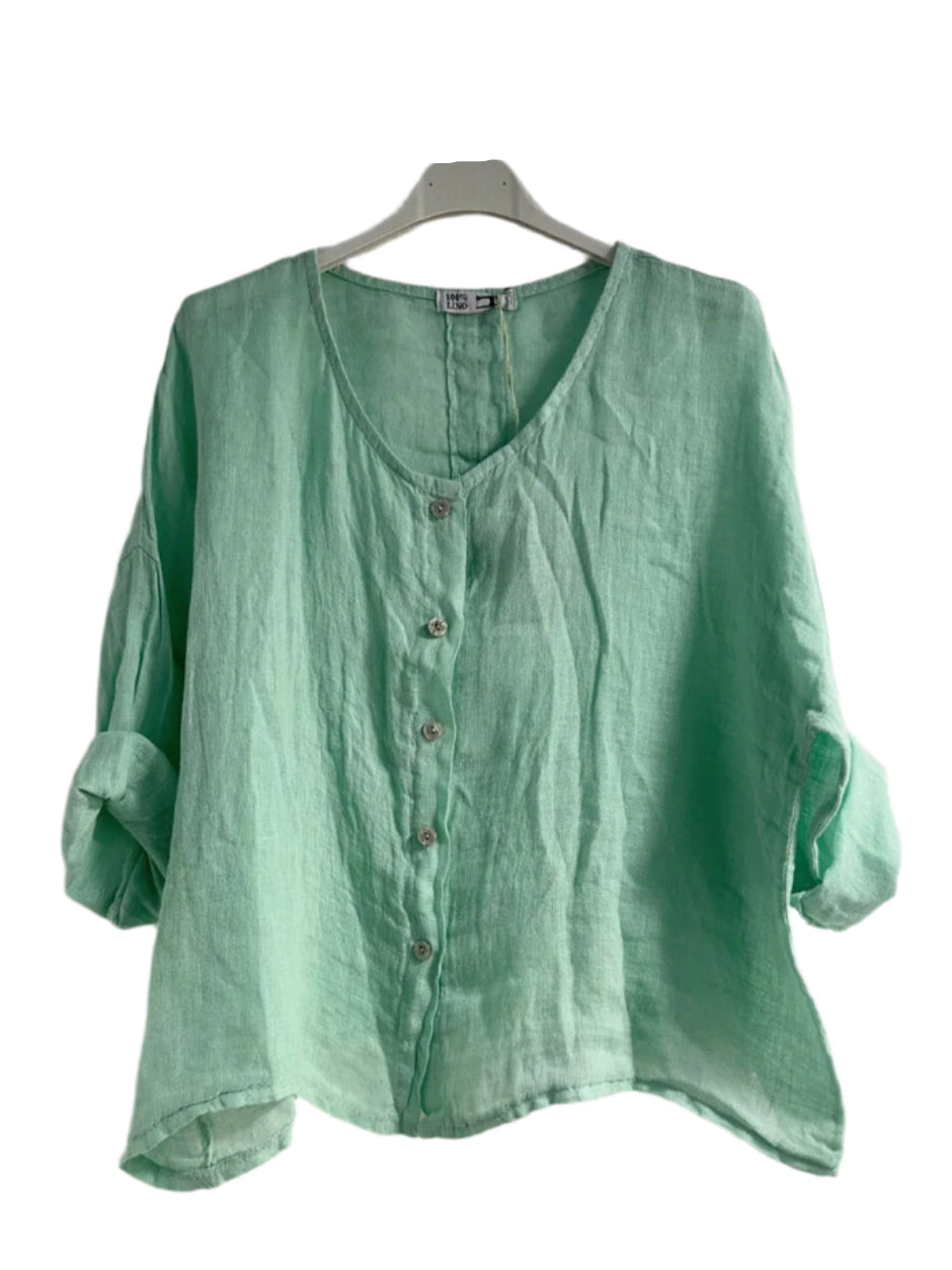 Pistachio shirt on a hanger against a white background