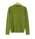 An olive green long-sleeve knit sweater with a ruffled mock neck and ruffled cuffs, 