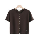 A dark brown short-sleeve knit top with a round neckline and a vertical row of pearl-like buttons down the front, 