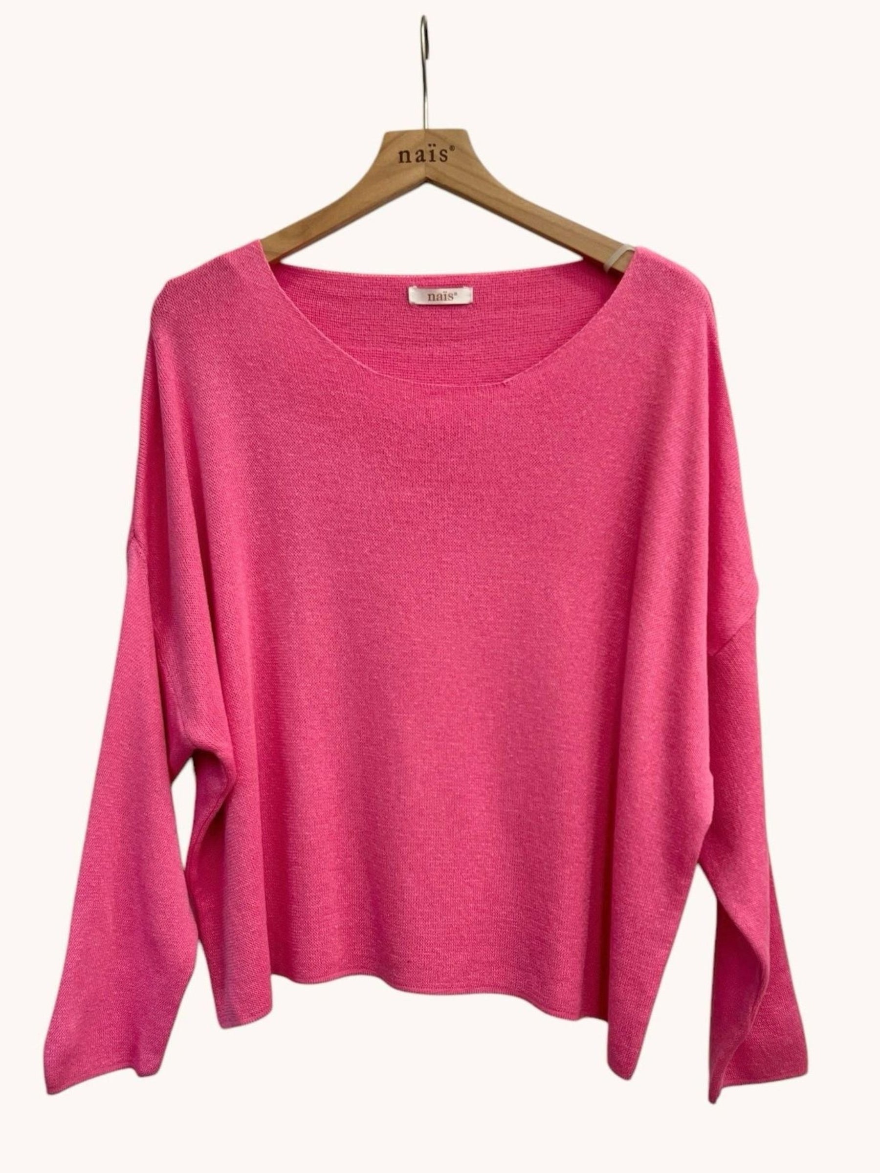 Pink sweater on a wooden hanger 