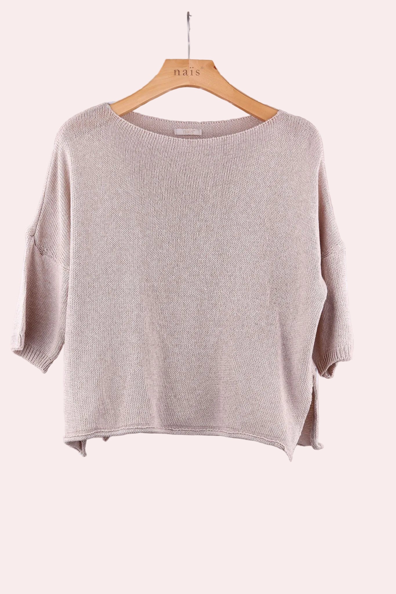 Beige sweater on a wooden hanger 