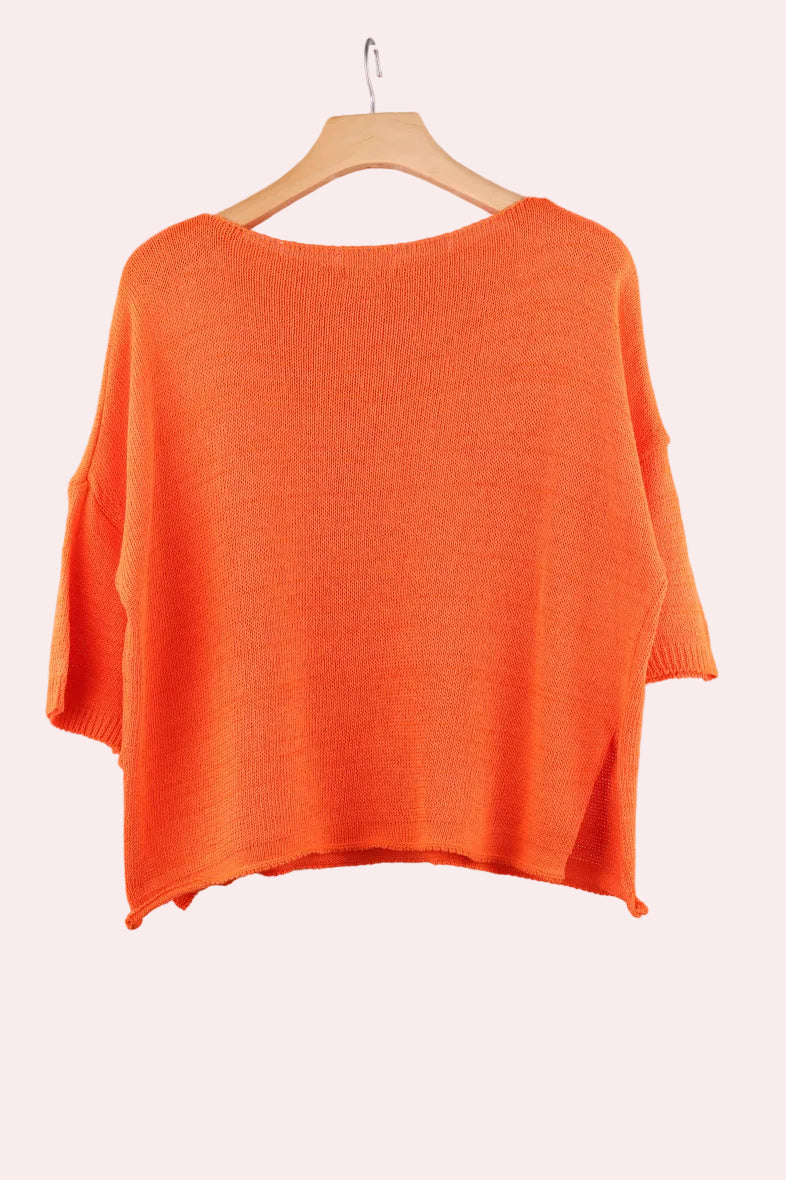 Orange sweater on a hanger 