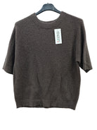 A short-sleeve knit sweater in dark brown, hanging on a black hanger 
