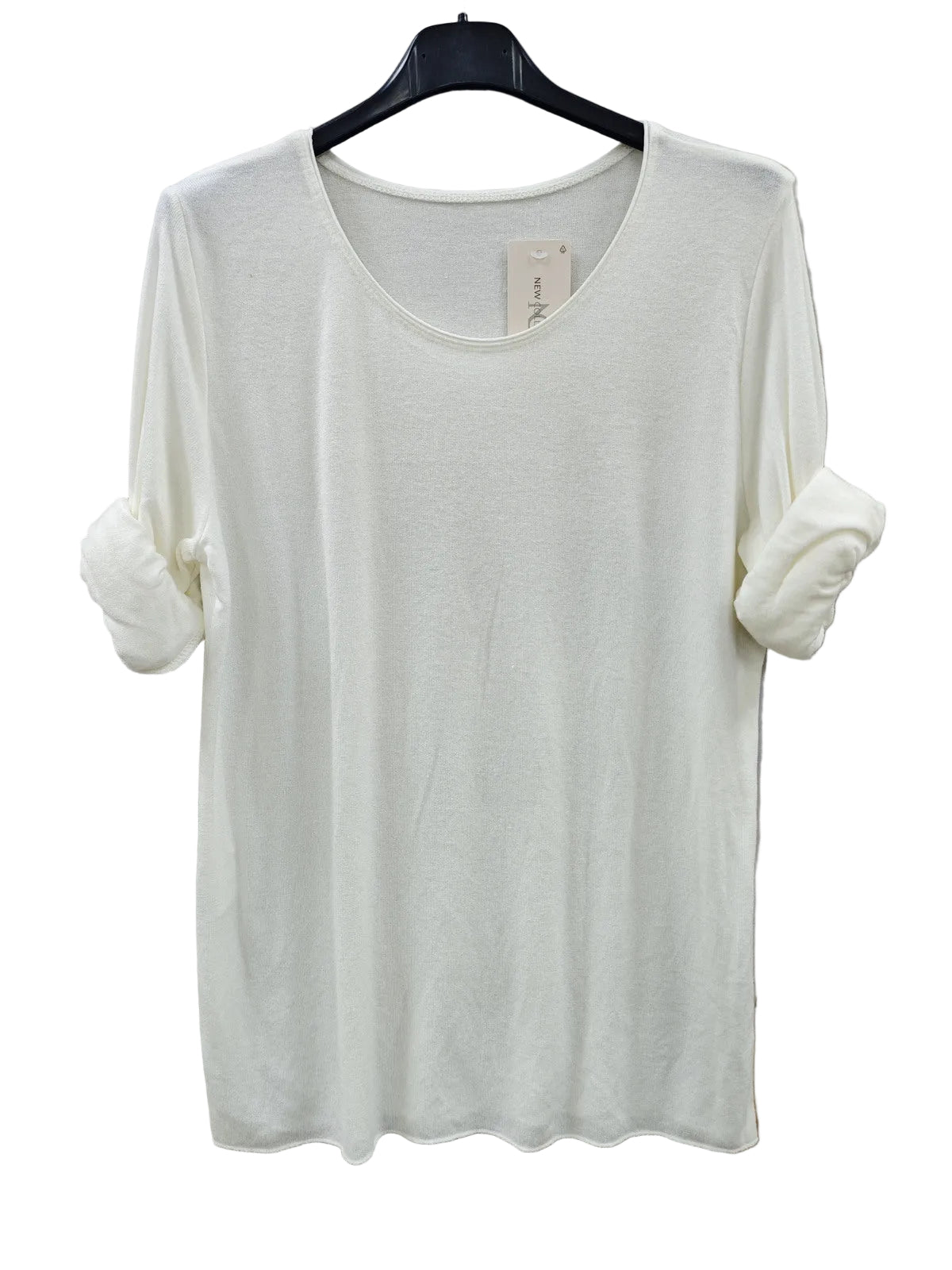 An off-white long-sleeve knit top with rolled-up sleeves, hanging on a black hanger 
