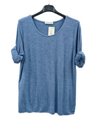 A heathered blue long-sleeve top with rolled cuffs, hanging on a black hanger 