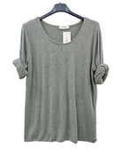 A heathered sage green knit top with a wide scoop neckline and rolled sleeves, hanging on a black hanger 
