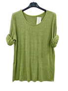 An olive green knit top with rolled sleeves, 