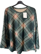 A women's long-sleeve plaid top hanging on a black hanger against a textured gray wall. The top features a muted green, brown, and beige tartan pattern