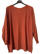 A rust-orange ribbed knit sweater 