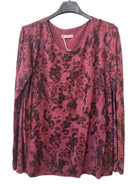 A long-sleeve scoop-neck top with a camouflage print in burgundy tones