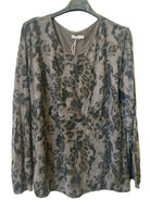 A long-sleeve crewneck top with an abstract camouflage print in brown, gray, and black