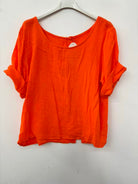 Orange shirt on a hanger against a white background