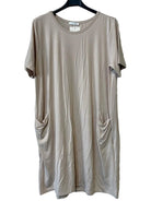 A short-sleeve beige tunic dress with draped side pockets