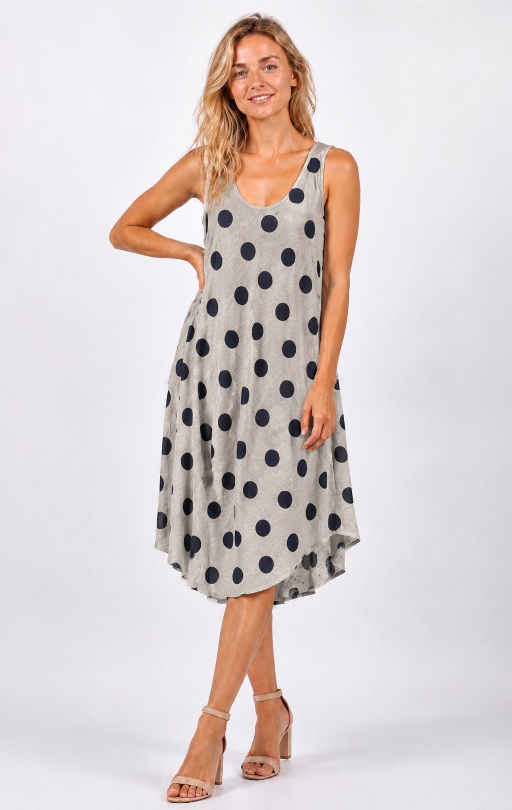 Woman wearing a polka dot dress on a white background
