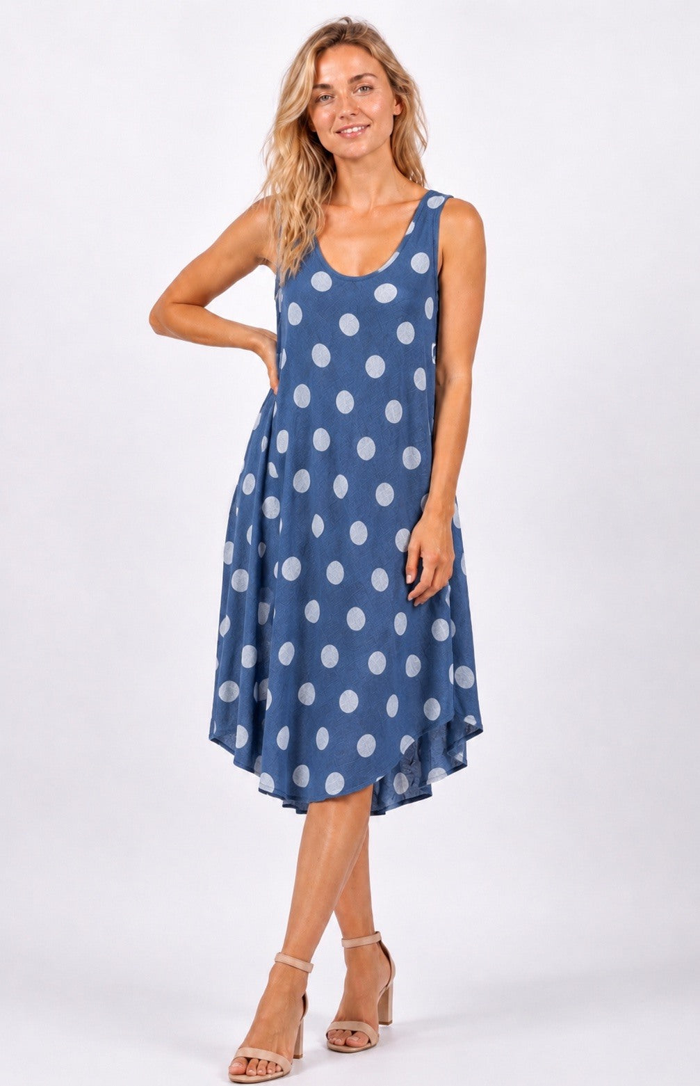Woman wearing a blue polka dot dress on a white background