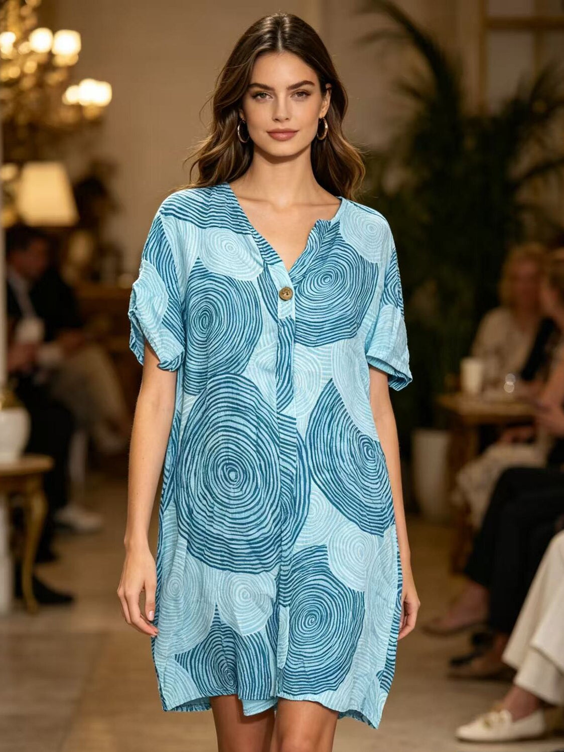 Woman wearing a blue patterned dress at an event