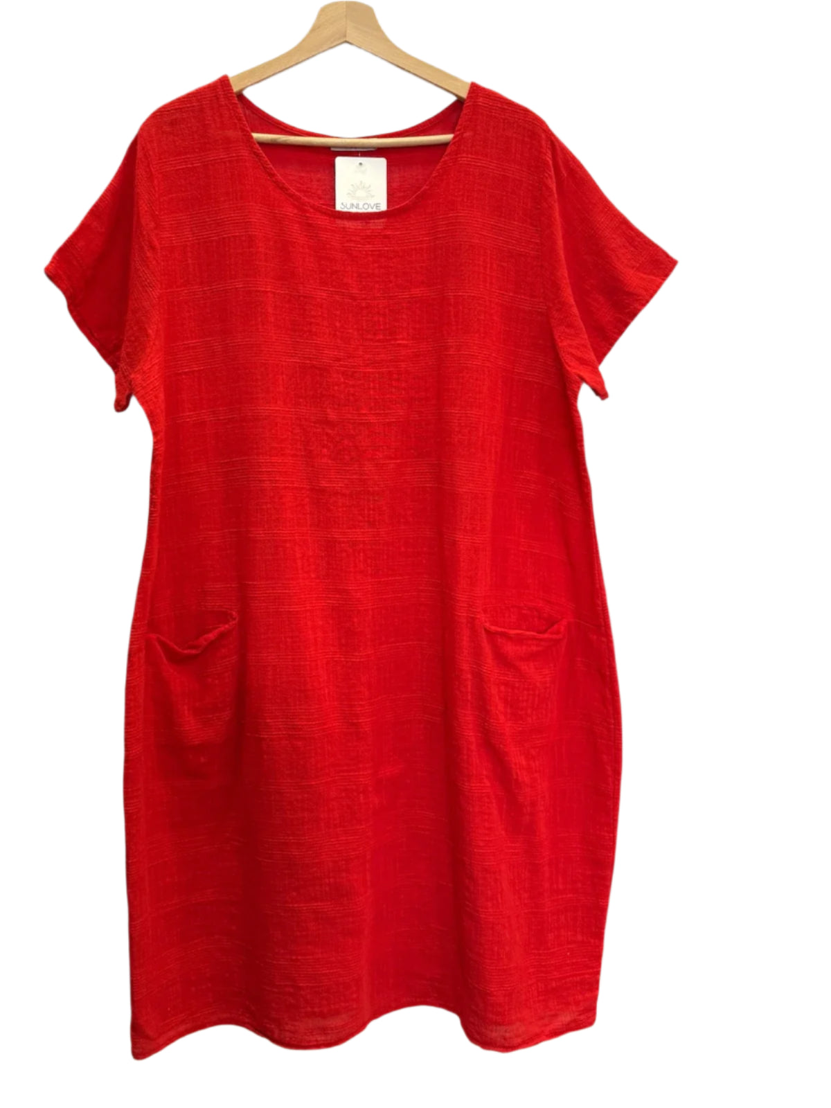 Red dress on a hanger against a white background