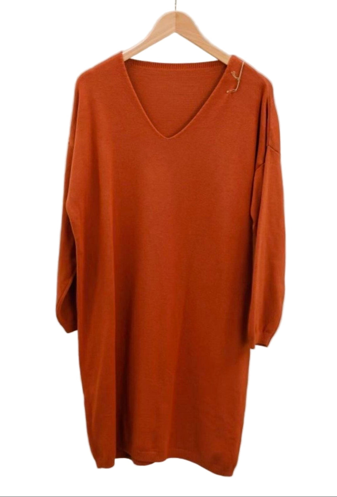 Orange dress on a hanger against a white background