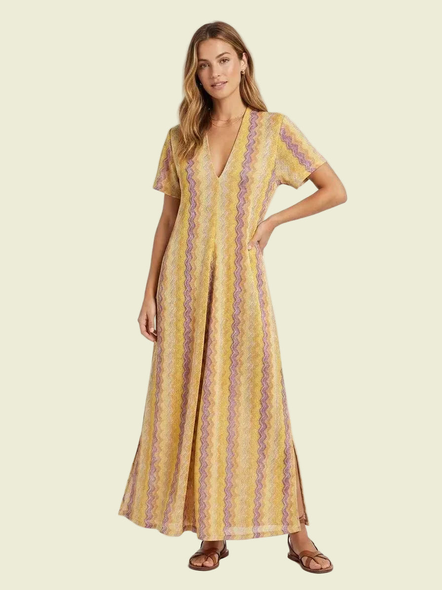Woman wearing a yellow patterned dress on a white background
