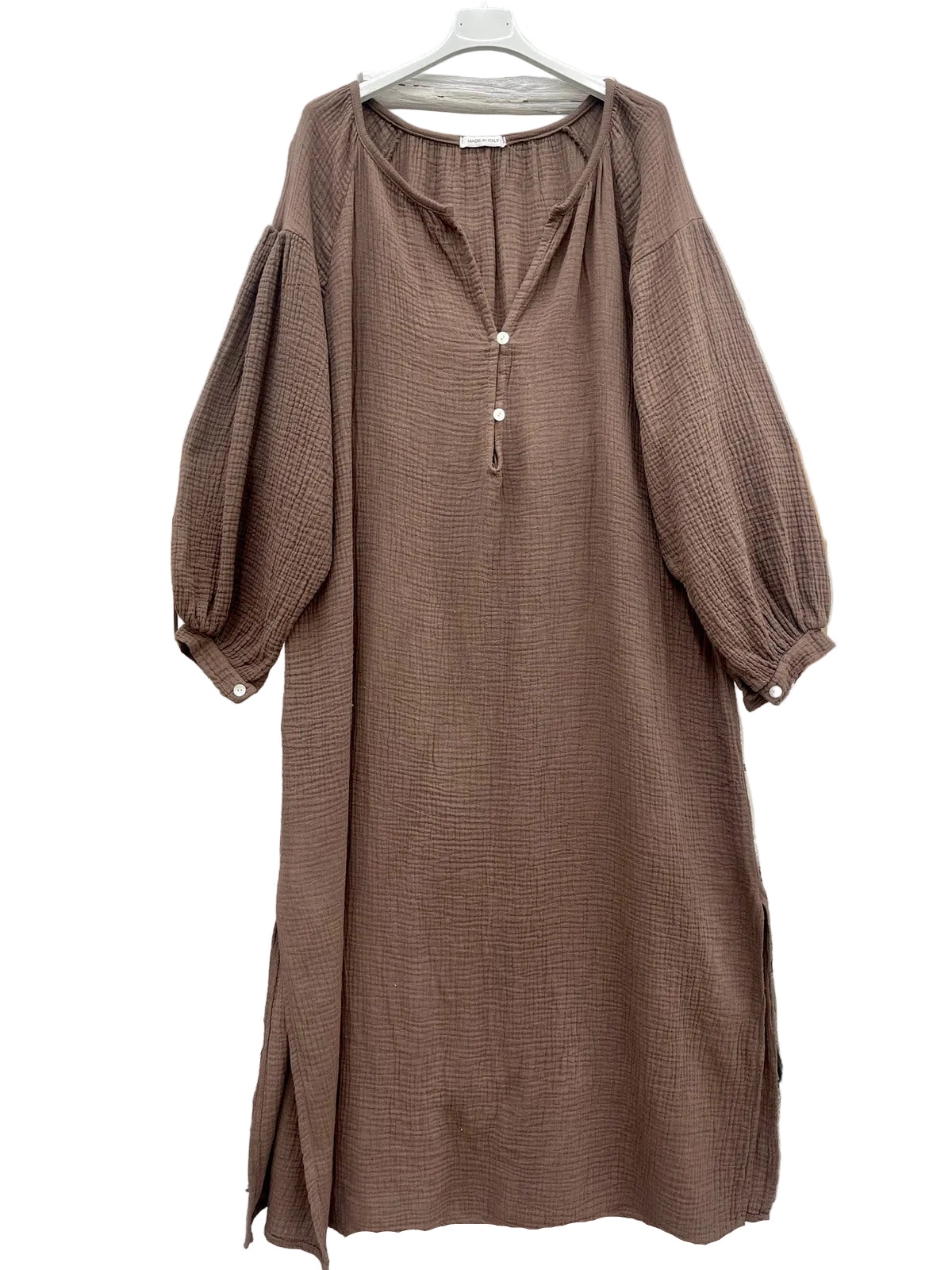 A brown textured midi dress with balloon sleeves and a tassel tie neckline,