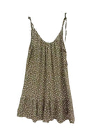 An khaki green sleeveless slip dress with a small white floral print stand.