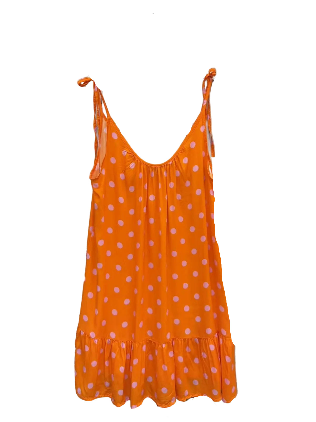 An orange sleeveless slip dress with white polka dots