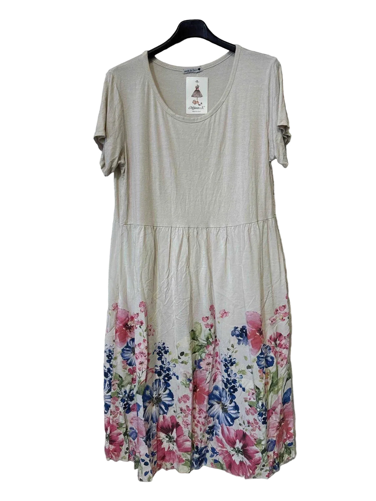 A short-sleeve beige dress with a colorful floral print concentrated along the hem