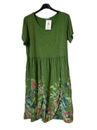 An olive green short-sleeve dress with a floral print at the hem