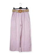 Pink trousers with a belt on a hanger against a white background