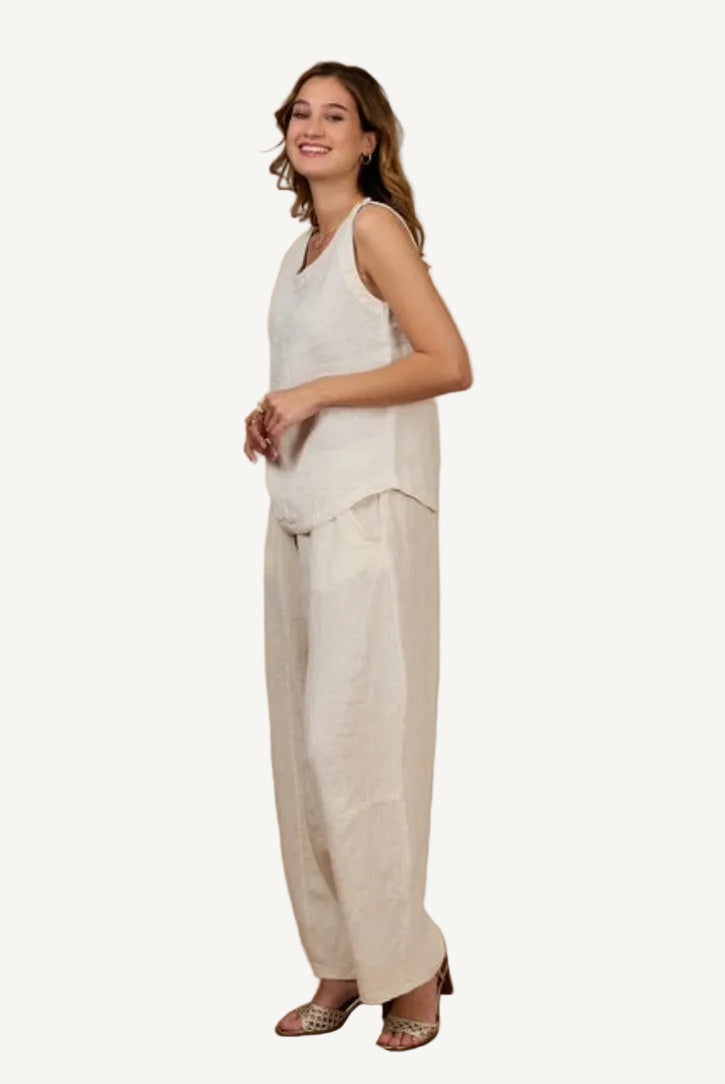 Woman wearing a sleeveless top and beige pants 