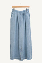 Sky blue denim wide-leg pants on a hanger against a white background