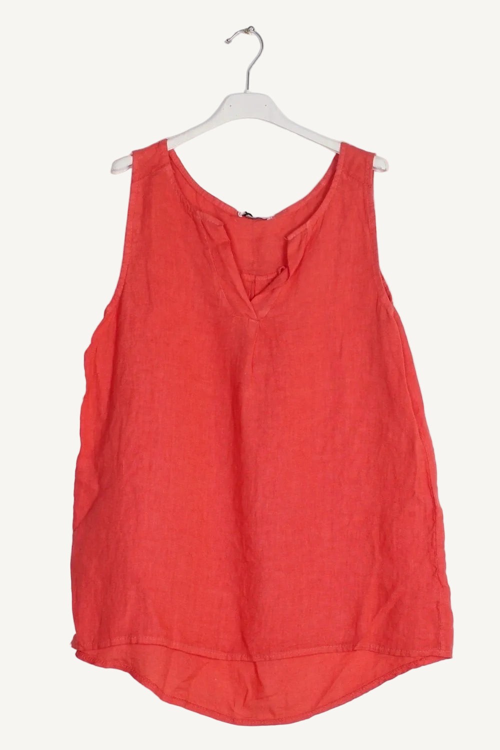 Coral sleeveless top on a white hanger 