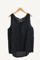 Navy blue sleeveless top on a wooden hanger 