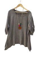 A taupe brown cotton top with three-quarter sleeves hanging on a wooden hanger