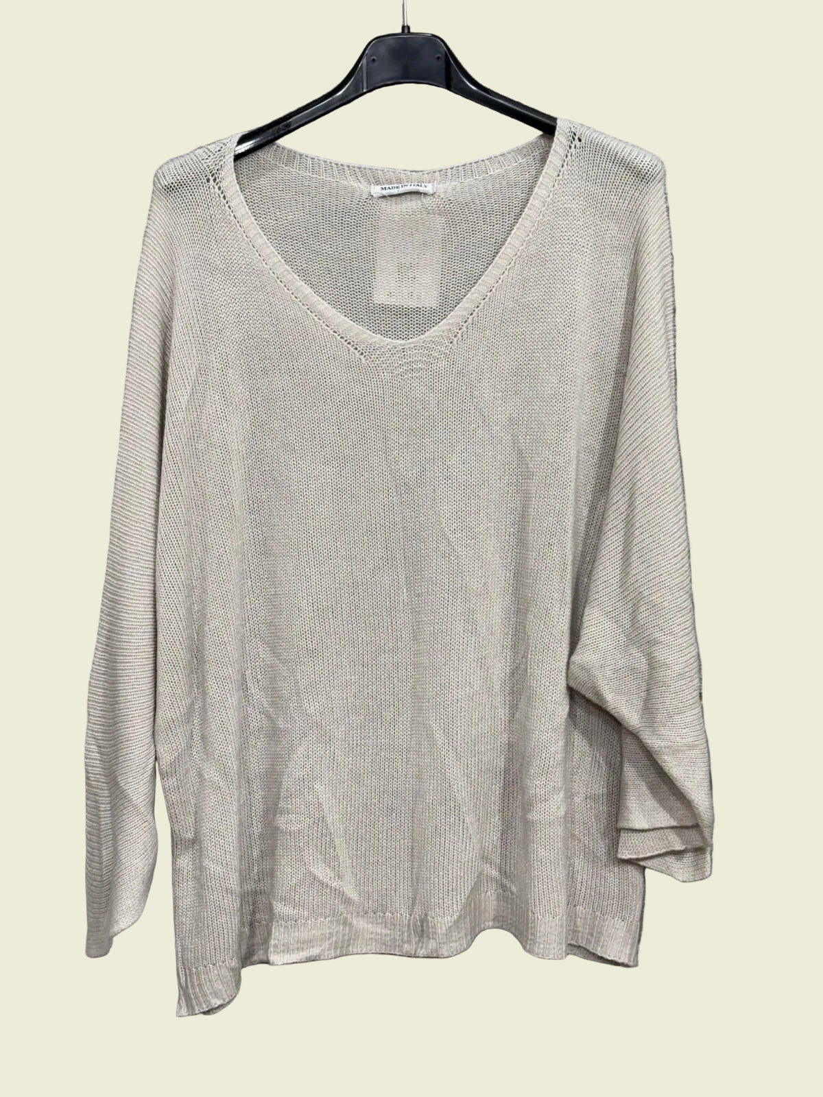 Beige sweater on a hanger 