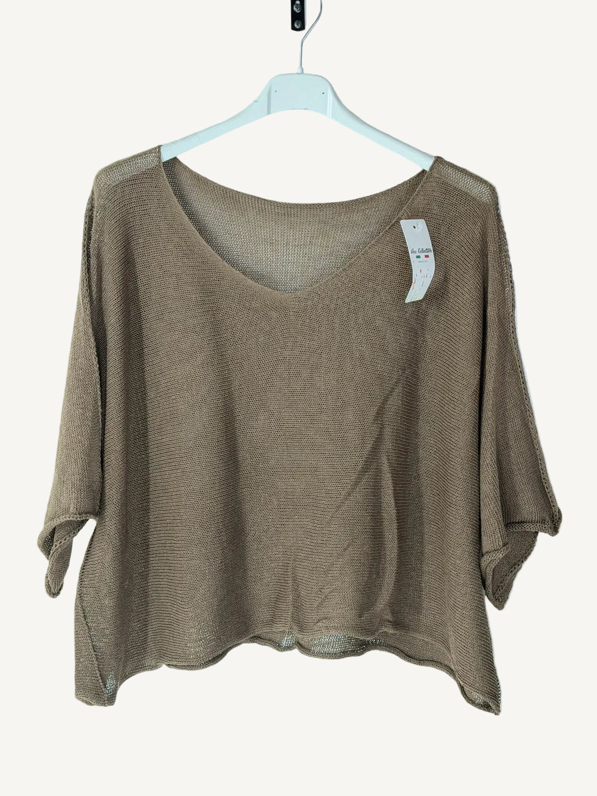 Brown knit top on a hanger against a white background