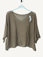 Brown knit top on a hanger against a white background