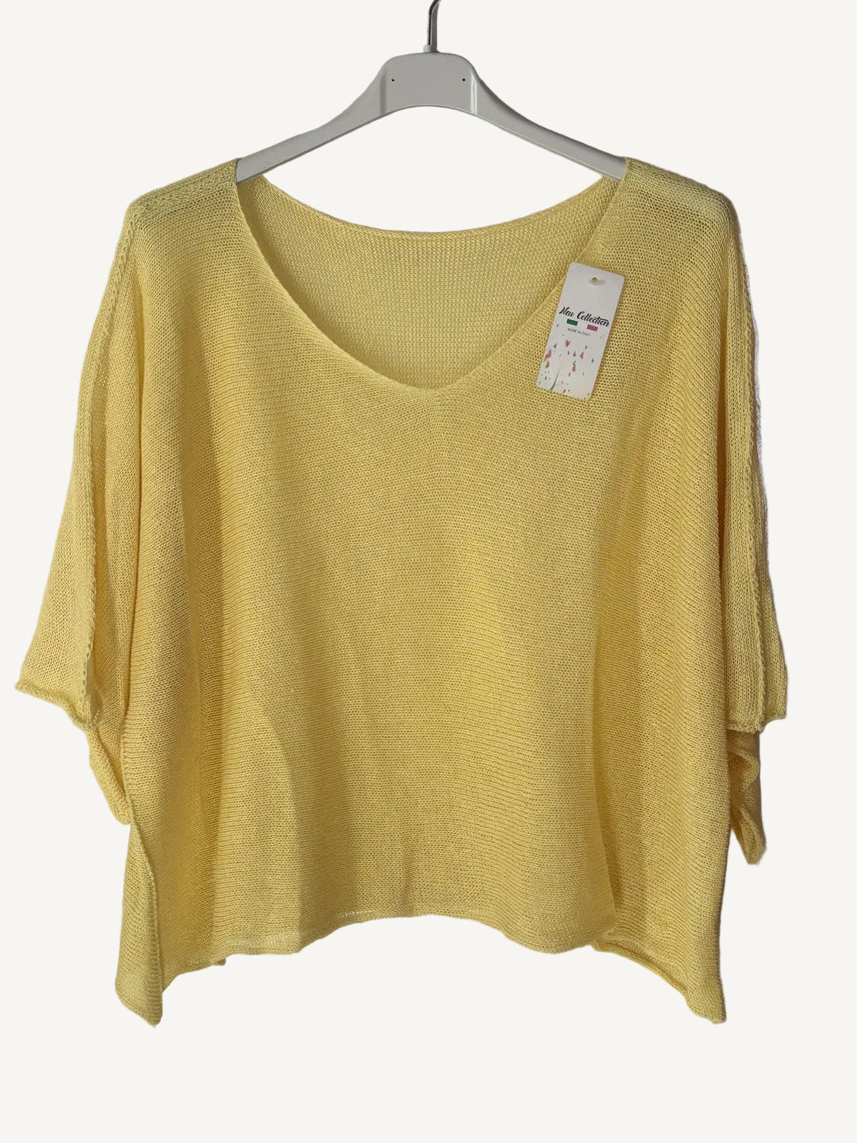 Yellow sweater on a hanger with a v neck